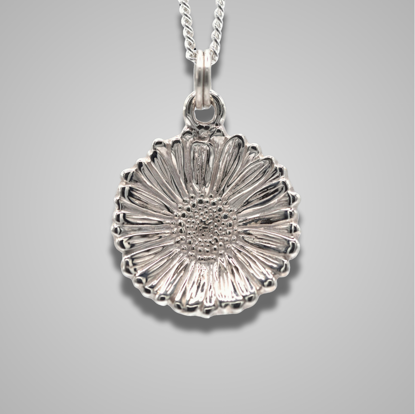 Realistic and unique, a delicate silver Daisy hangs from a silver chain. Highly detailed and shiny.