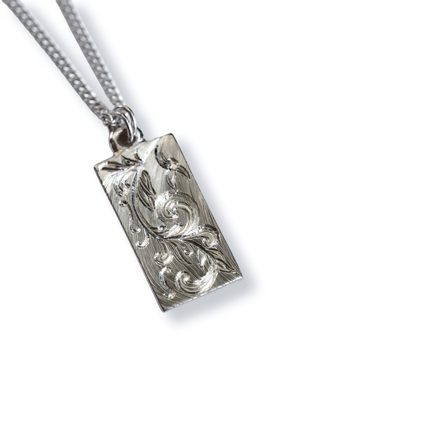 Silver pendant necklace WITH HAND ENGRAVED SCROLL PATTERN on a white background
