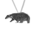 Silver badger pendant on a chain against a white background