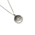 Silver necklace with a daisy pendant on a white background