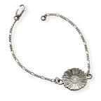 Silver bracelet with a single daisy on a white background