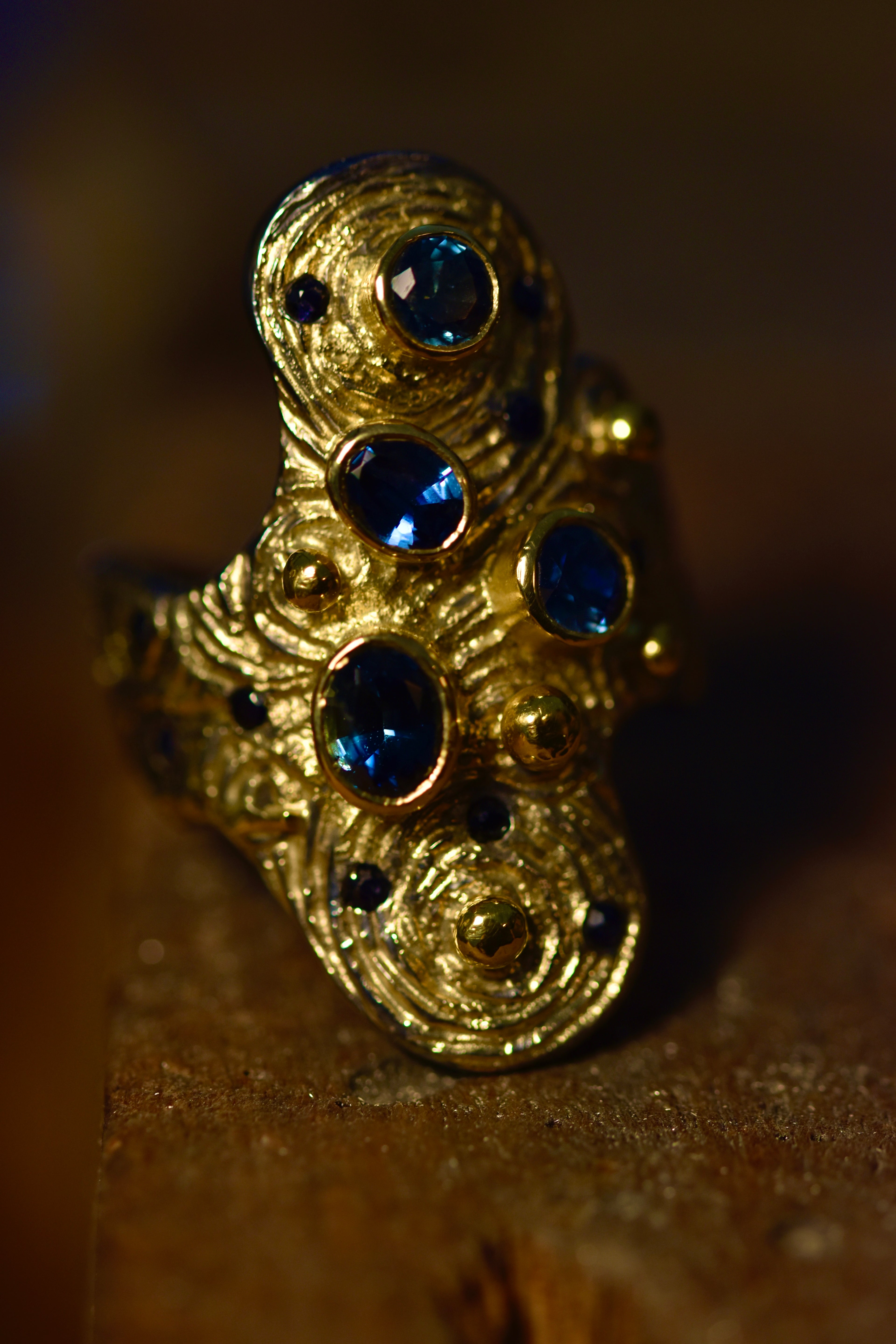 gold ring with blue sapphires set at angles