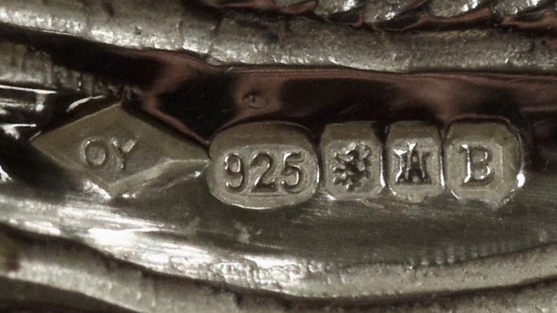 Close-up of a silver object with '925' hallmark