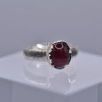 Silver ring with a wavy setting with a pink tourmaline stone in the centre