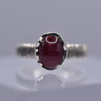 Silver ring with a wavy setting with a pink tourmaline stone in the centre