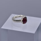 Silver ring with a wavy setting with a pink tourmaline stone in the centre