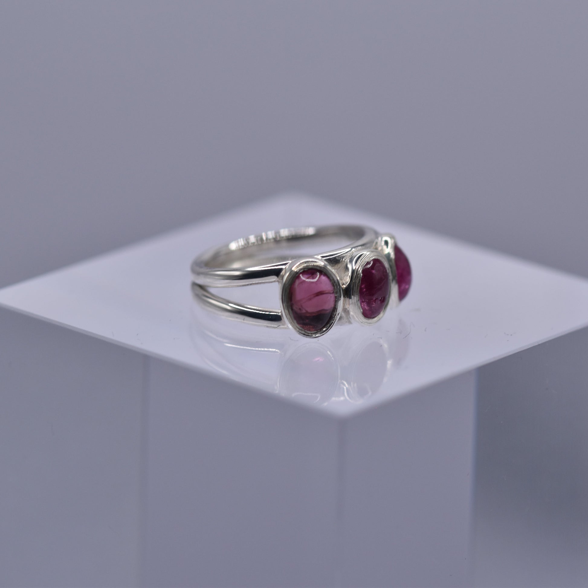 A spilt shank ring with 3 Pink tourmaline stones