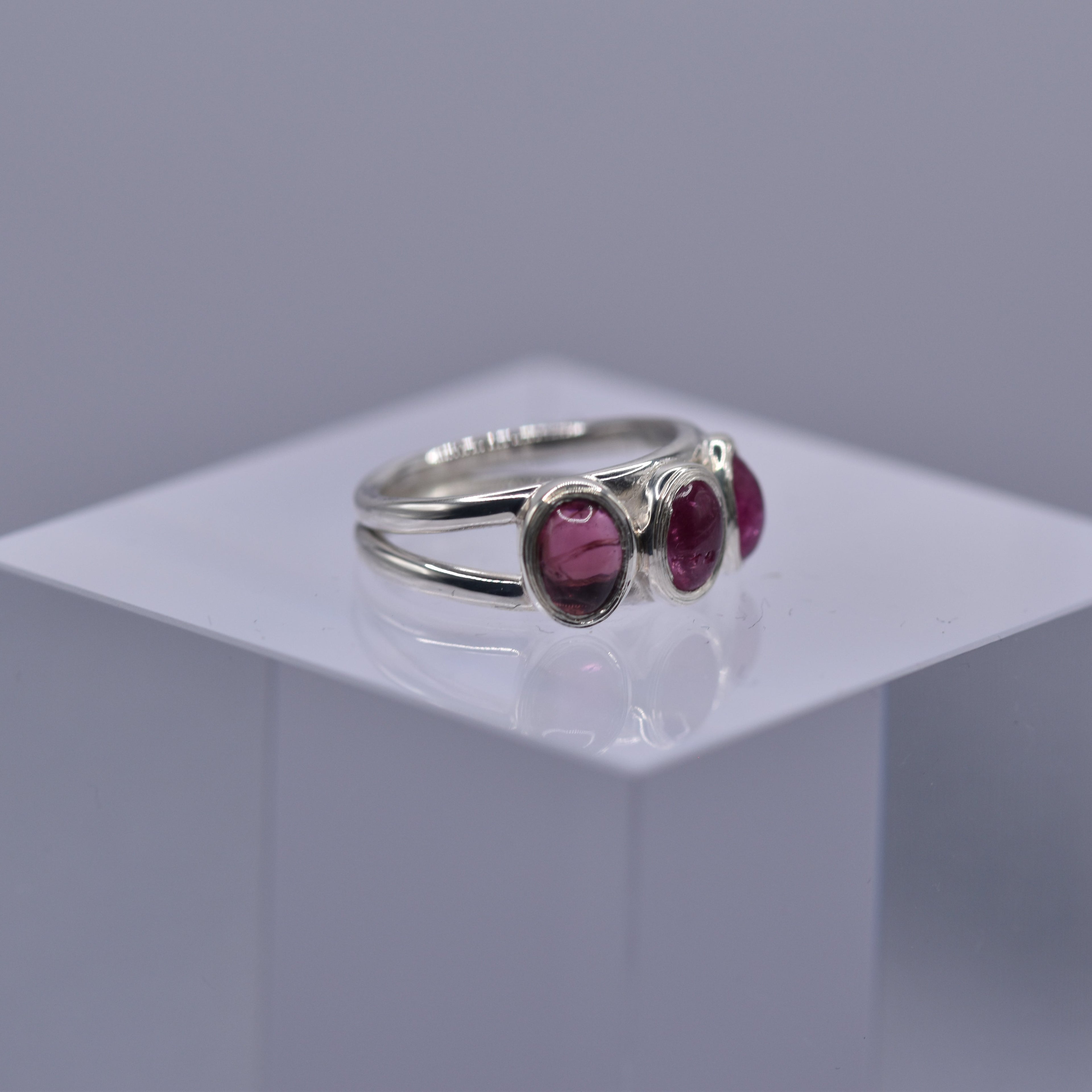 A spilt shank ring with 3 Pink tourmaline stones