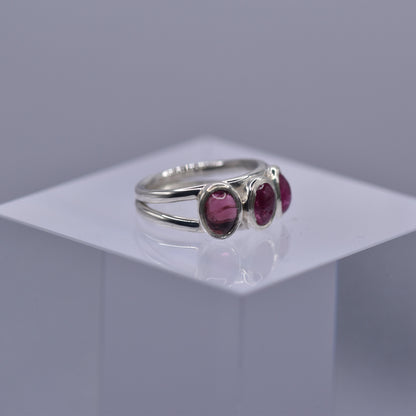 A spilt shank ring with 3 Pink tourmaline stones