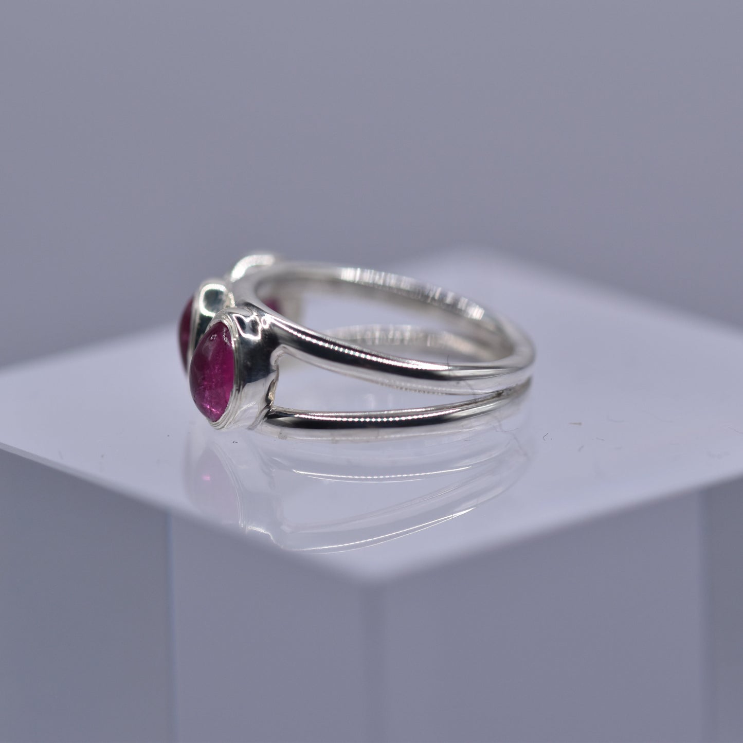 A spilt shank ring with 3 Pink tourmaline stones