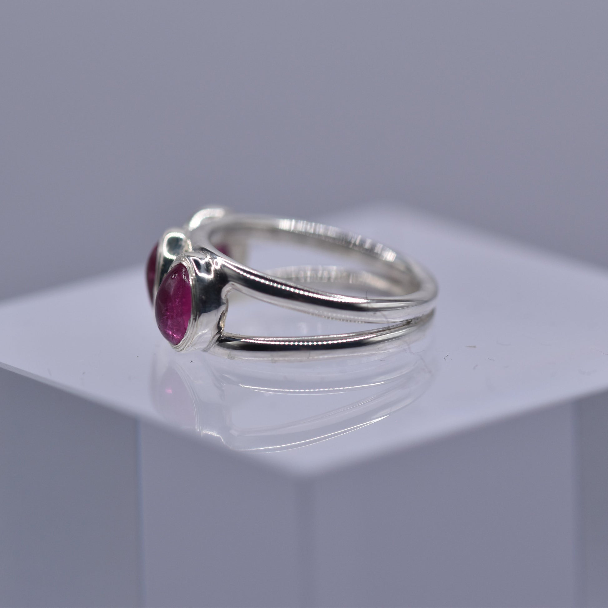 A spilt shank ring with 3 Pink tourmaline stones