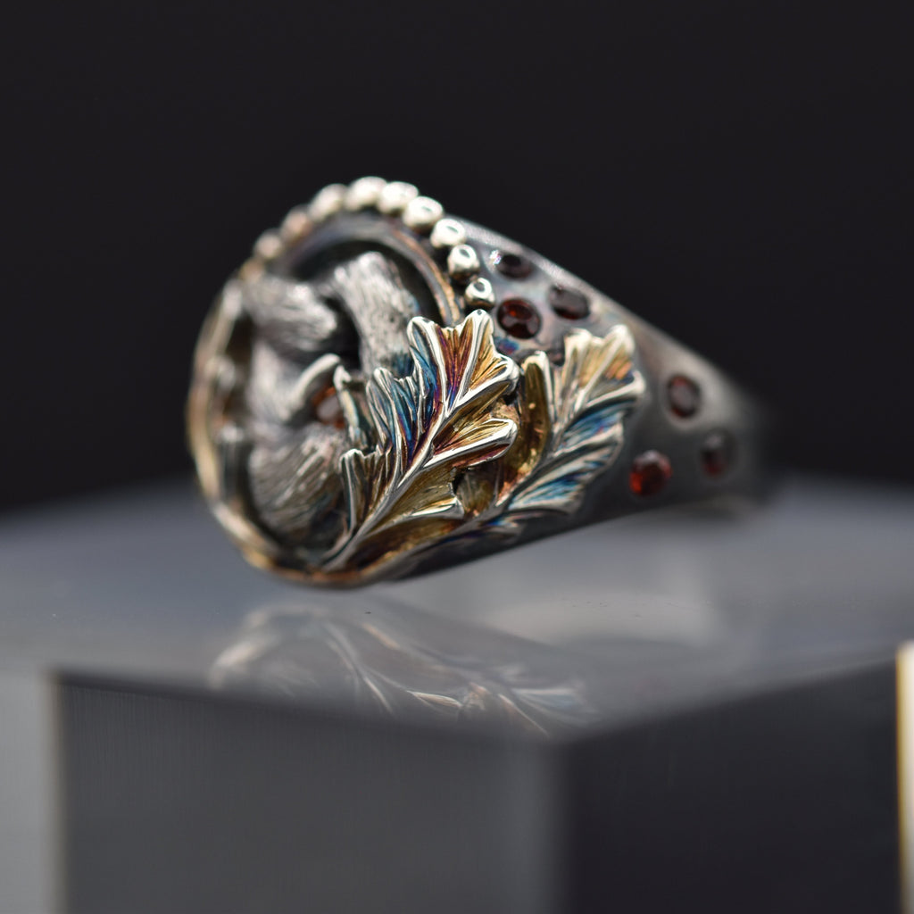 Decorative ring with intricate design on a reflective surface