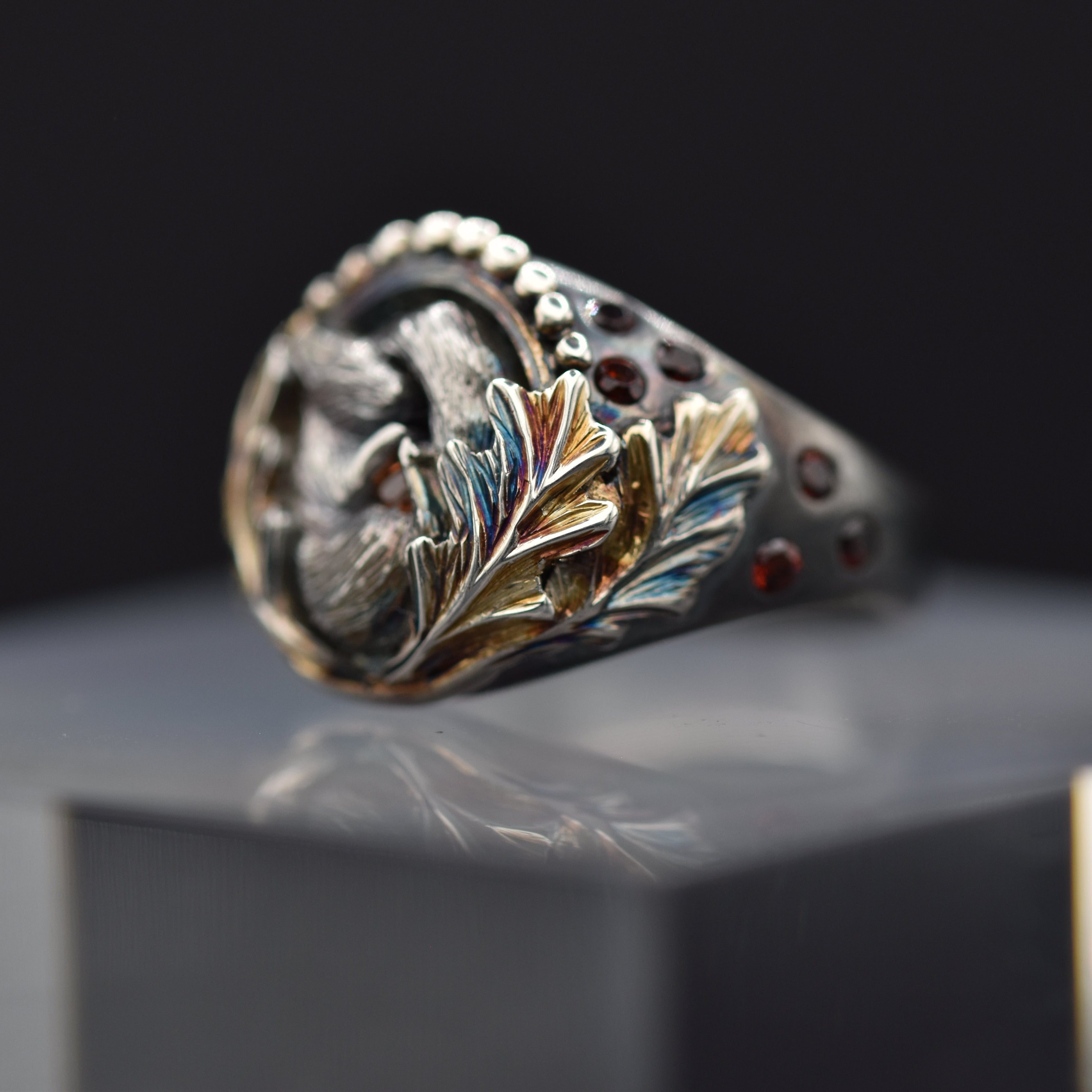 Decorative ring with intricate design on a reflective surface
