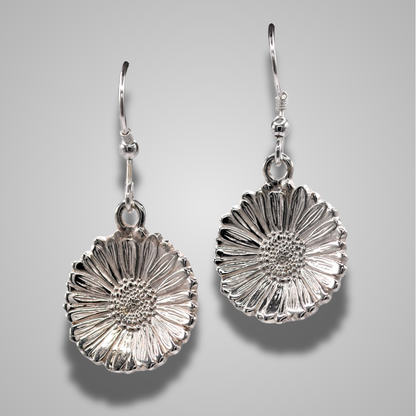 Realistic silver daisies as earrings on silver hooks. Detailed and elegant