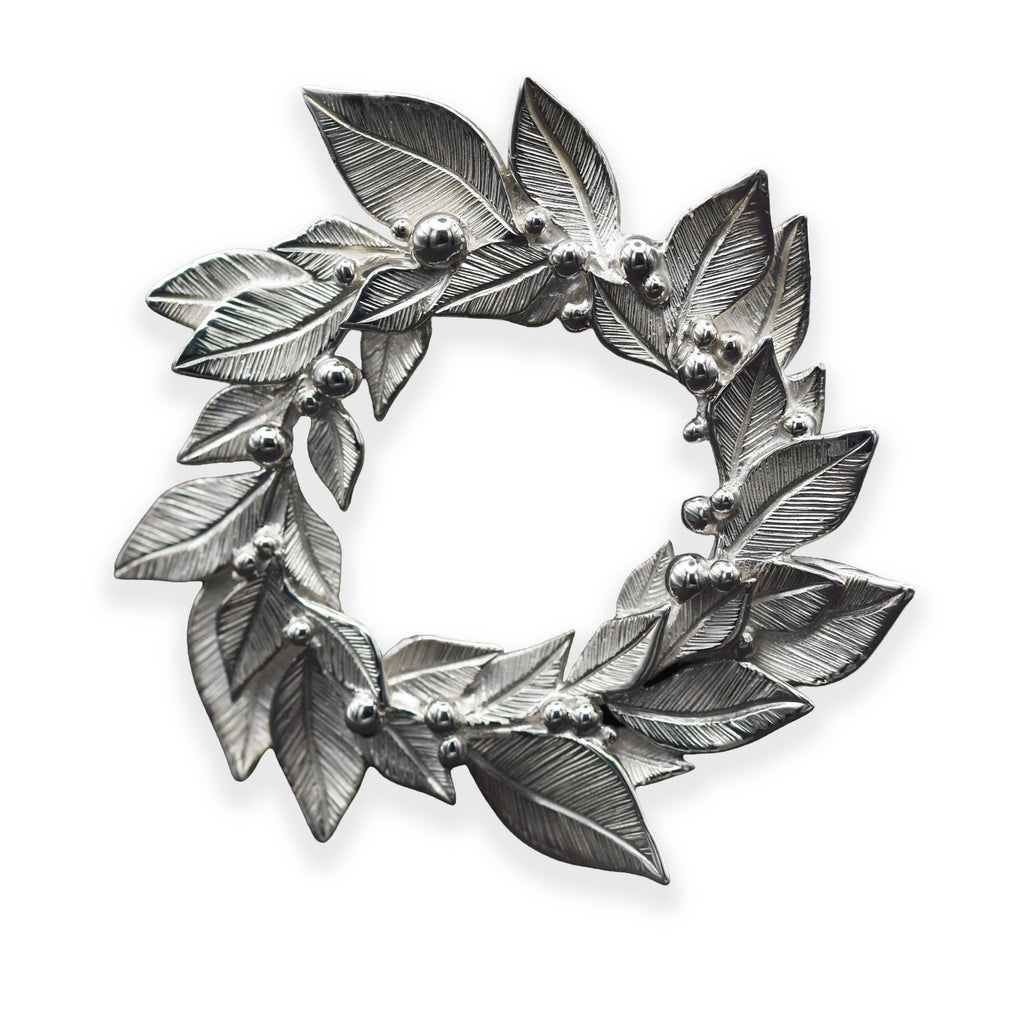 Silver leaf wreath brooch on a white background