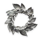 Silver leaf wreath brooch on a white background