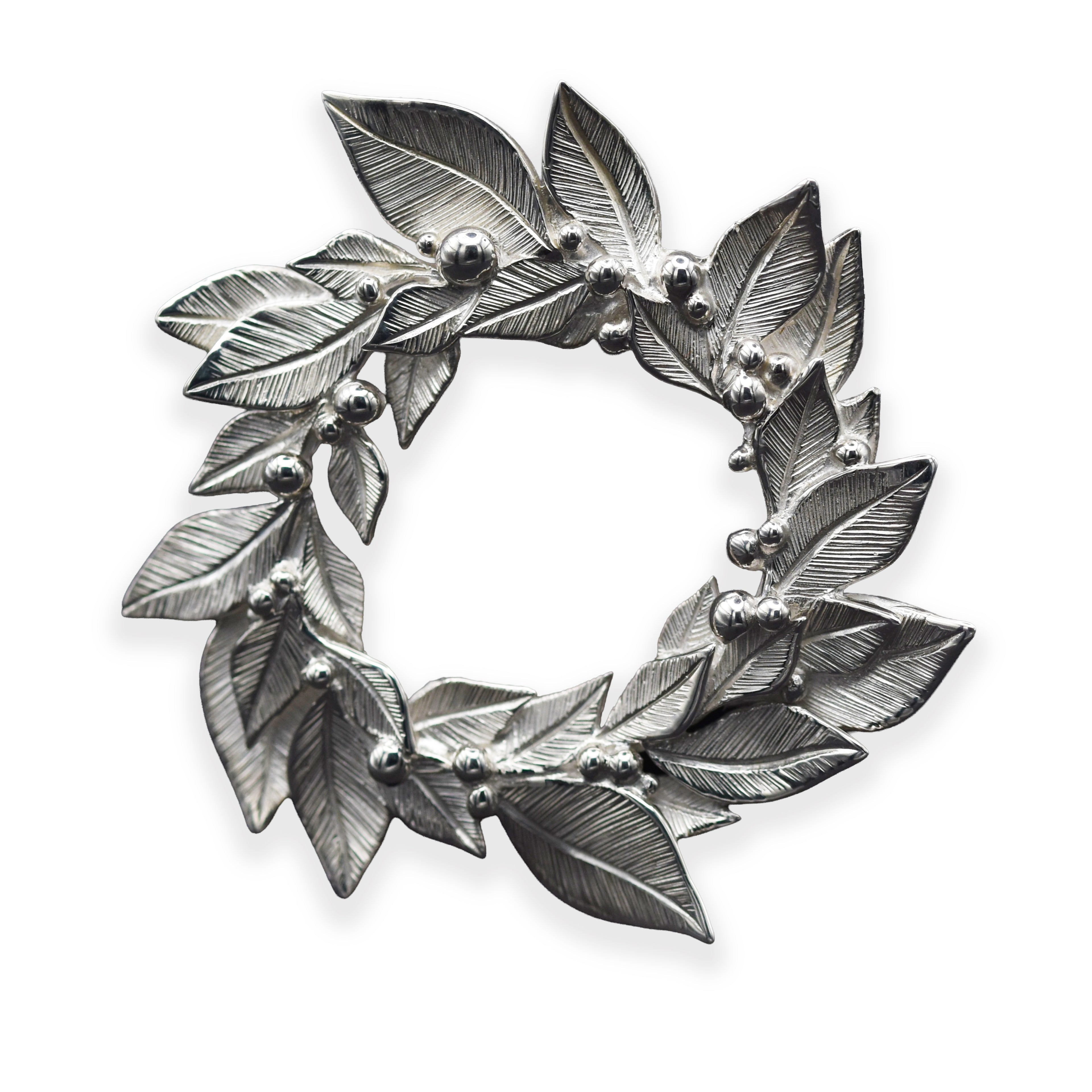 Silver leaf wreath brooch on a white background