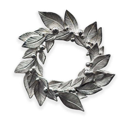 Silver leaf wreath brooch on a white background