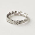 silver ring with flowers all the way around 
