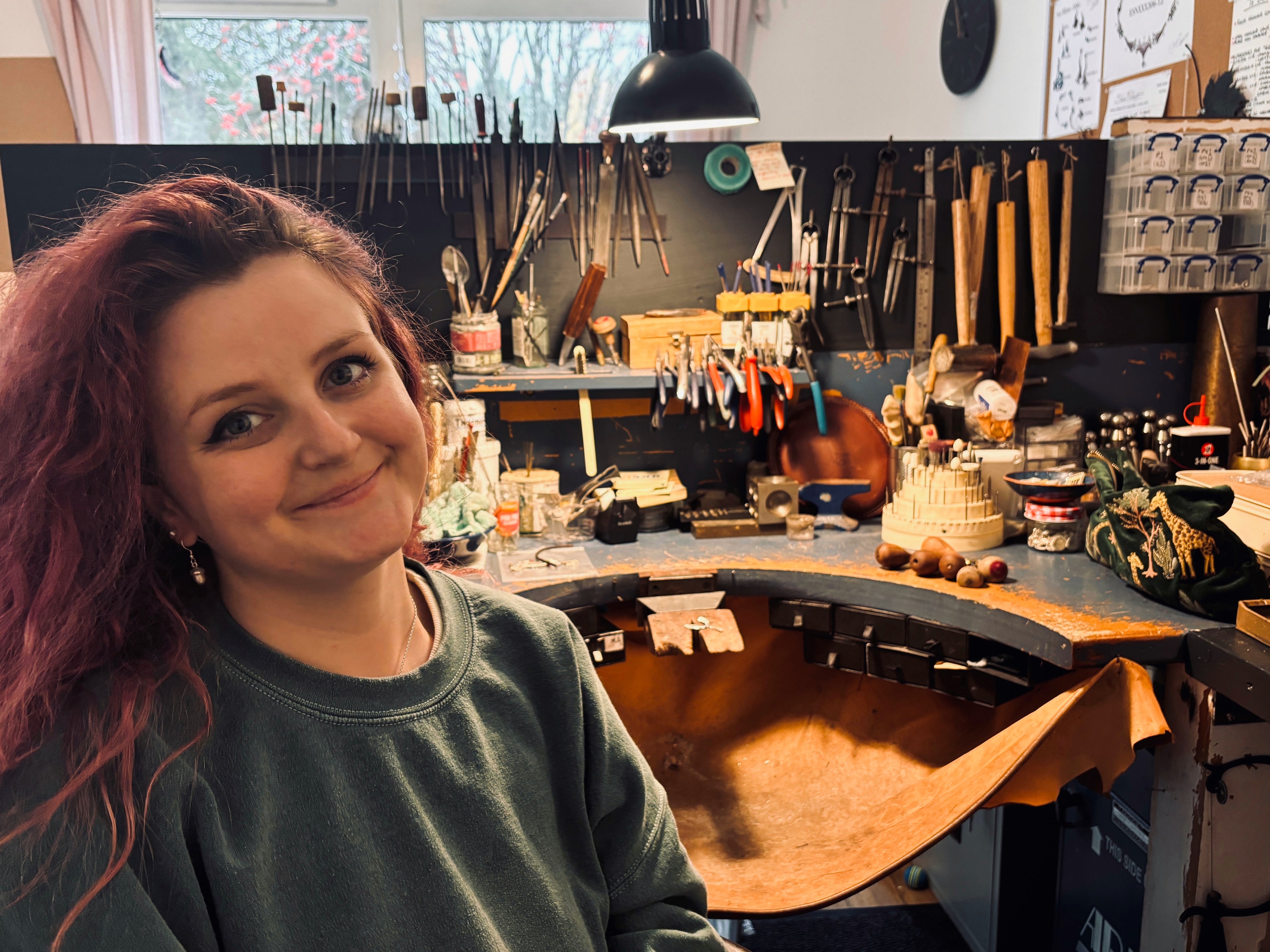 Woman in a jewellery workshop surrounded by tools