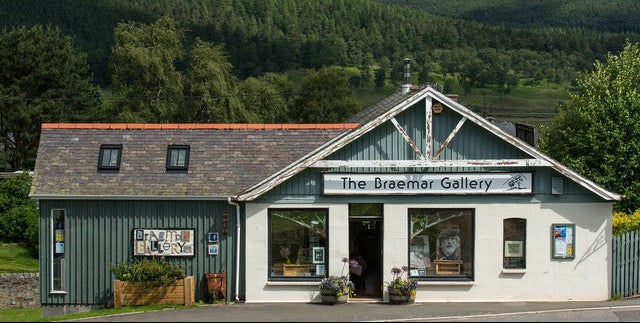 The Braemar Gallery building with a green exterior and white trim, surrounded by trees.