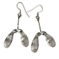 Silver sycamore seed earrings on a white background