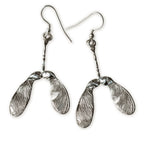 Silver sycamore seed earrings on a white background
