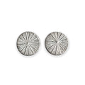 Pair of silver circular earrings with radiating design on a white background