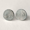 Pair of silver spiral earrings on a light gray background