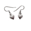 Pair of silver heart-shaped earrings on a white background