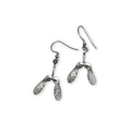 Silver earrings with sycamore seed shapes on a white background