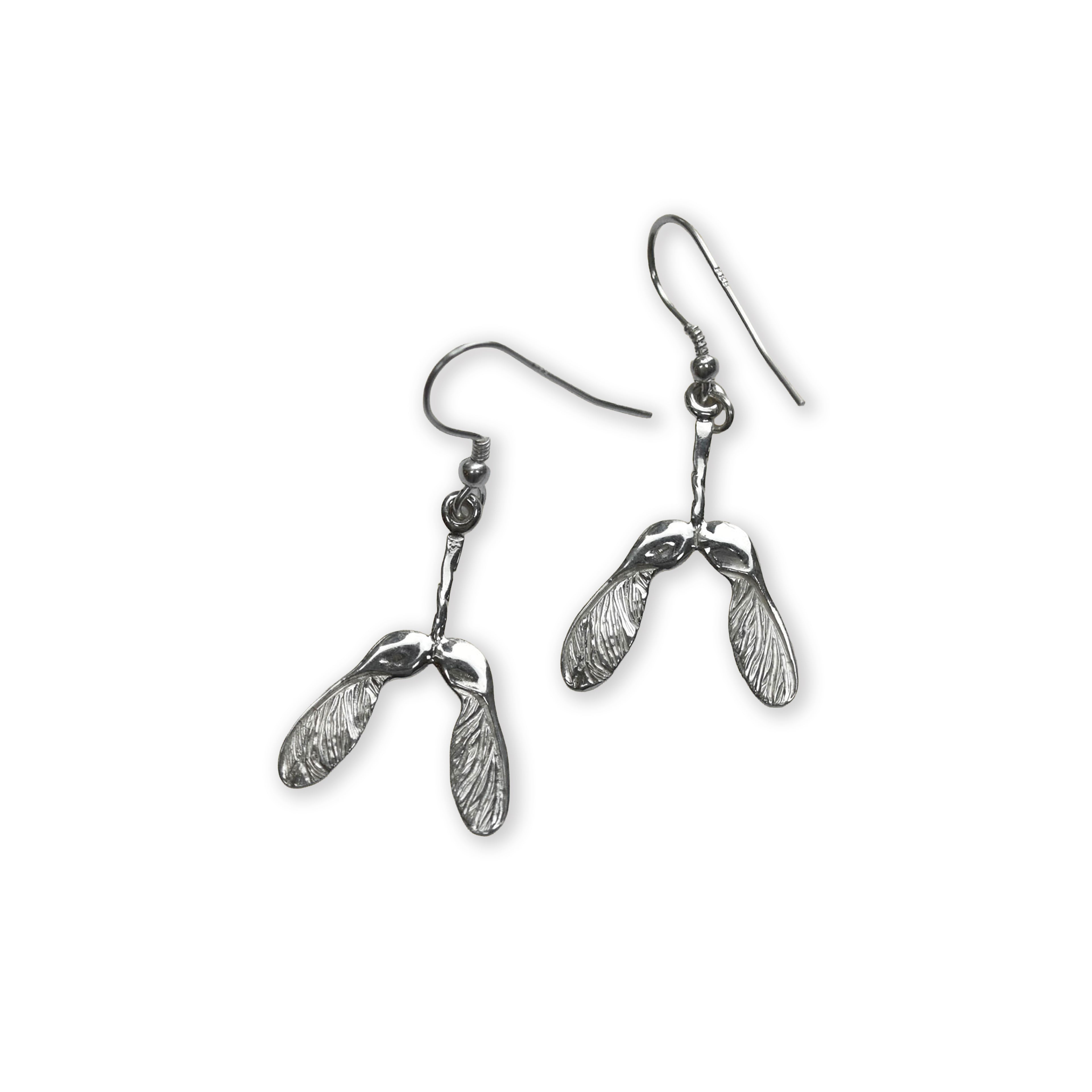Silver earrings with sycamore seed shapes on a white background