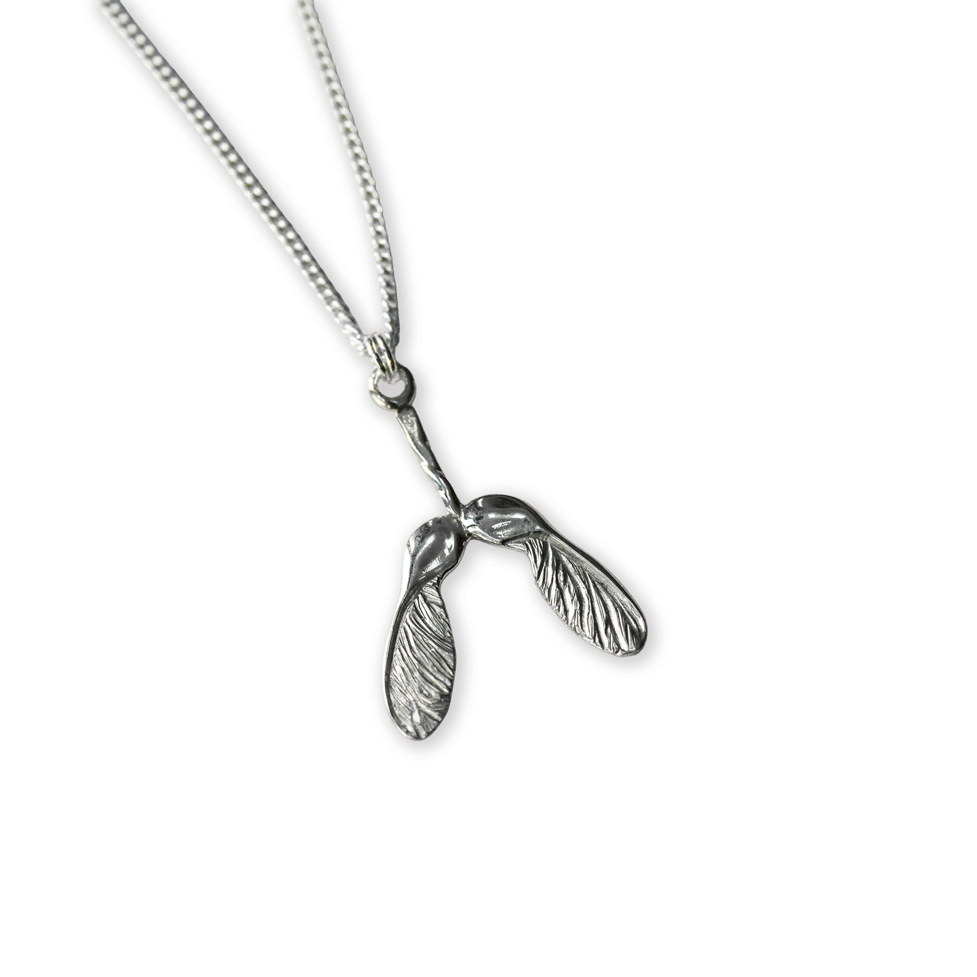 Silver necklace with a sycamore seed pendant on a white background