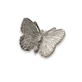 Silver butterfly-shaped pin on a white background