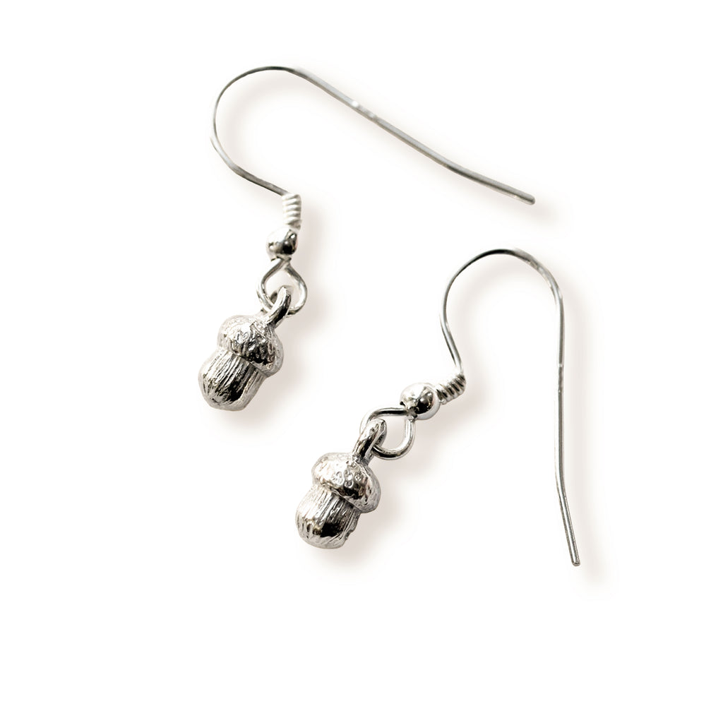 Pair of silver acorn earrings on a white background