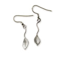 Silver leaf-shaped earrings on flowing wire on a white background