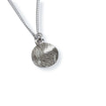 Silver necklace with a textured pendant on a white background