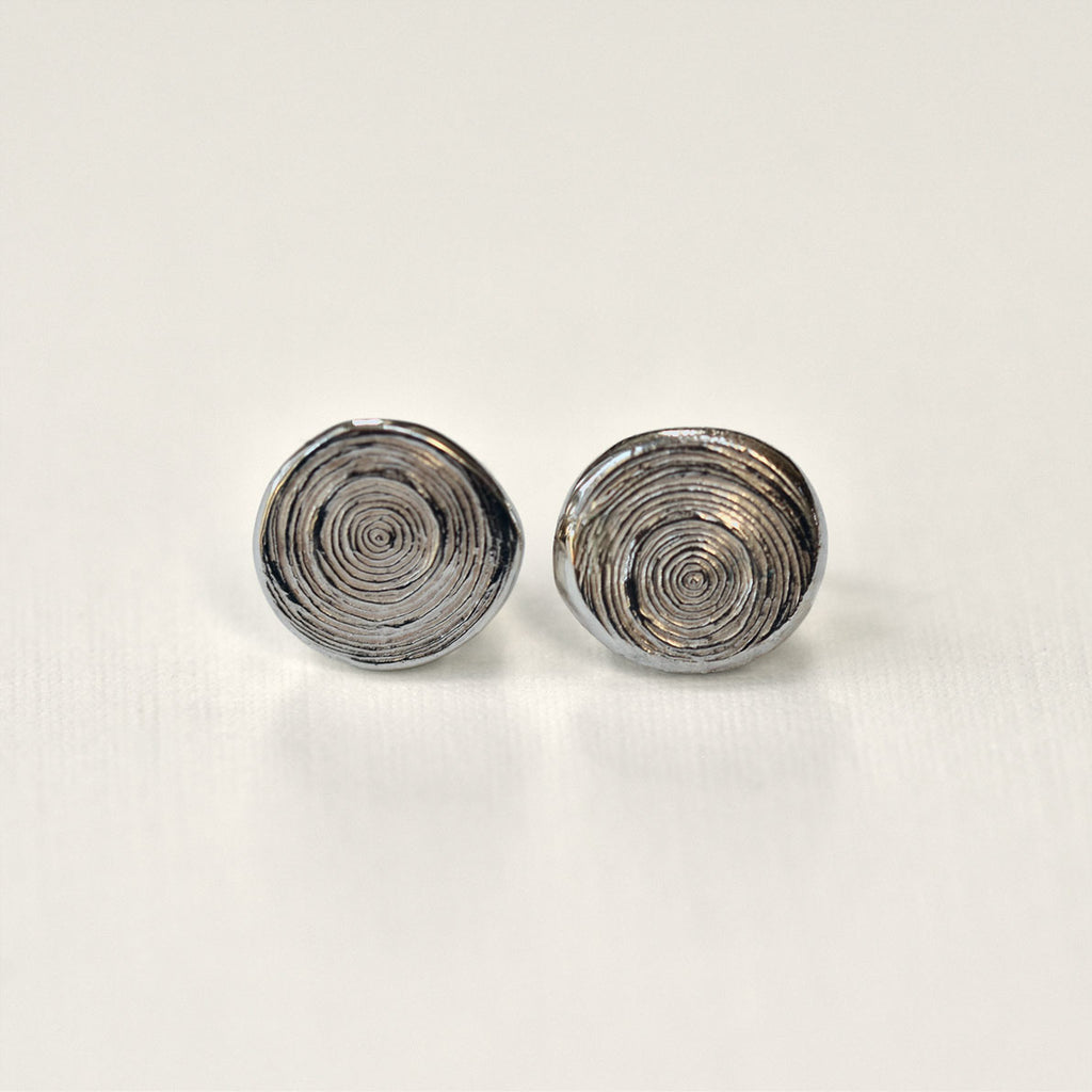 Pair of silver spiral earrings on a light gray background