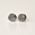 Pair of silver spiral earrings on a light gray background