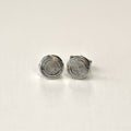Pair of silver spiral earrings on a white background