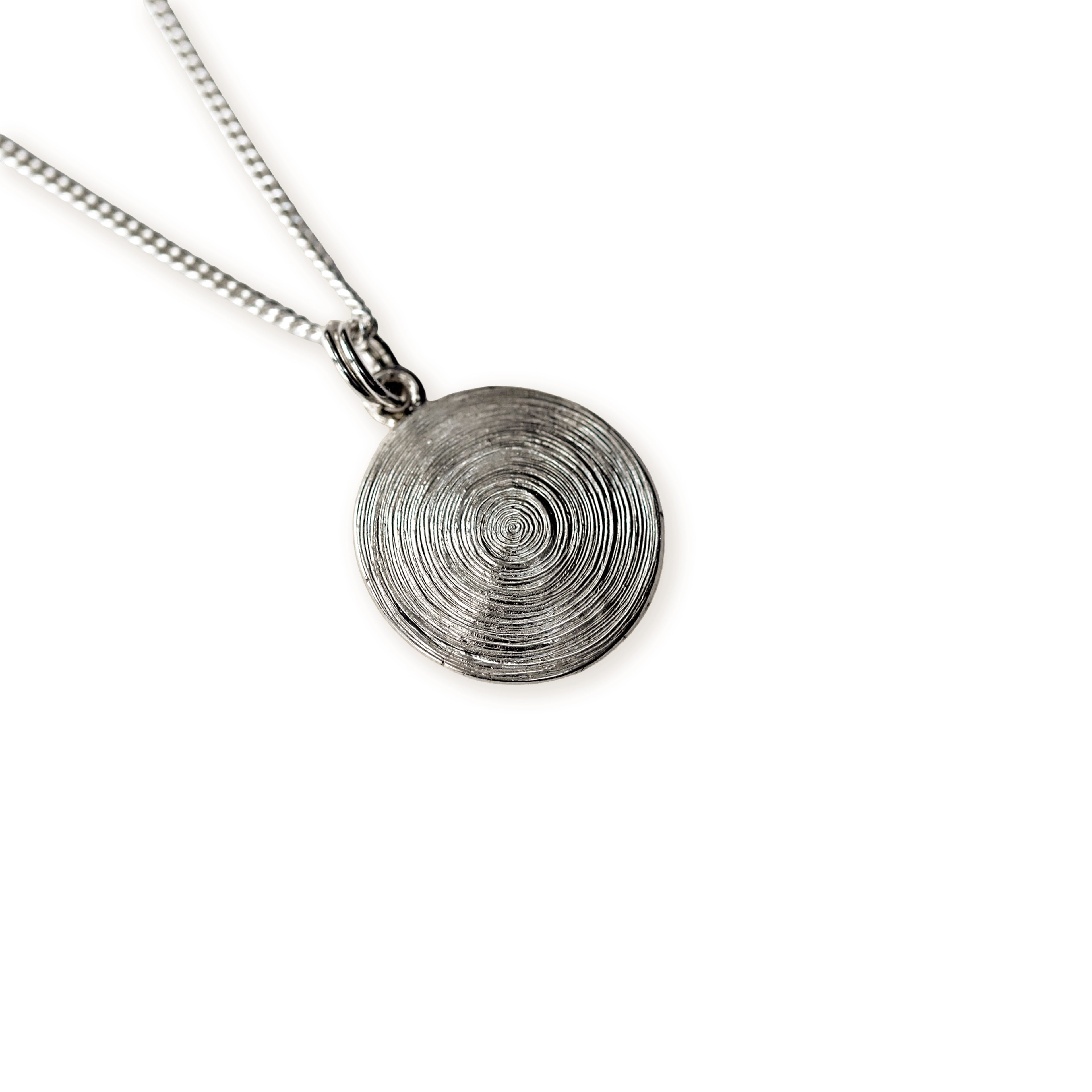 Silver circular pendant with concentric circles necklace on a white background