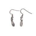 Pair of silver sycamore seed shaped earrings on a white background