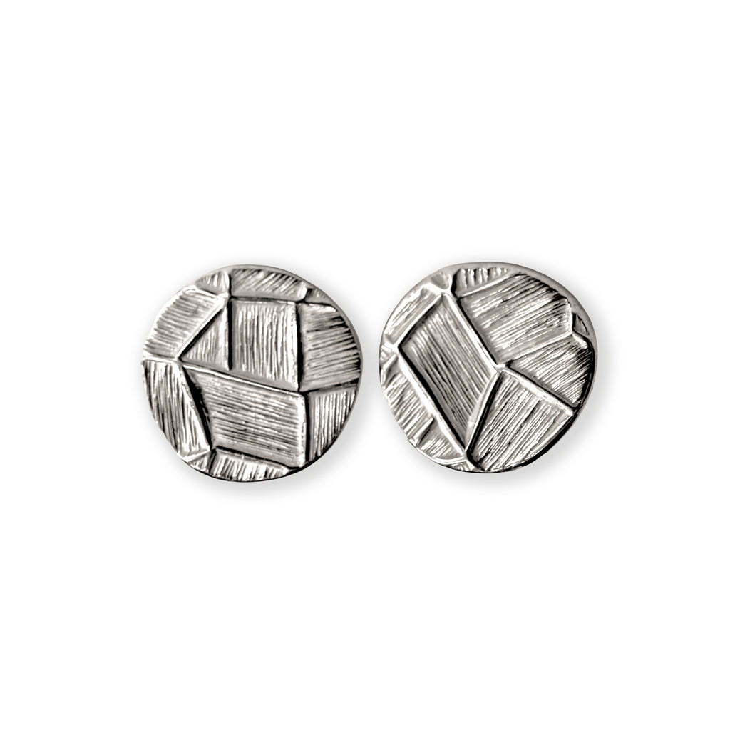 Pair of silver geometric earrings on a white background